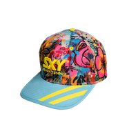 A colorful snapback hat with a geometric pattern featuring pink and yellow tones, and the text 'SXY BEACH TENNIS' on the front.